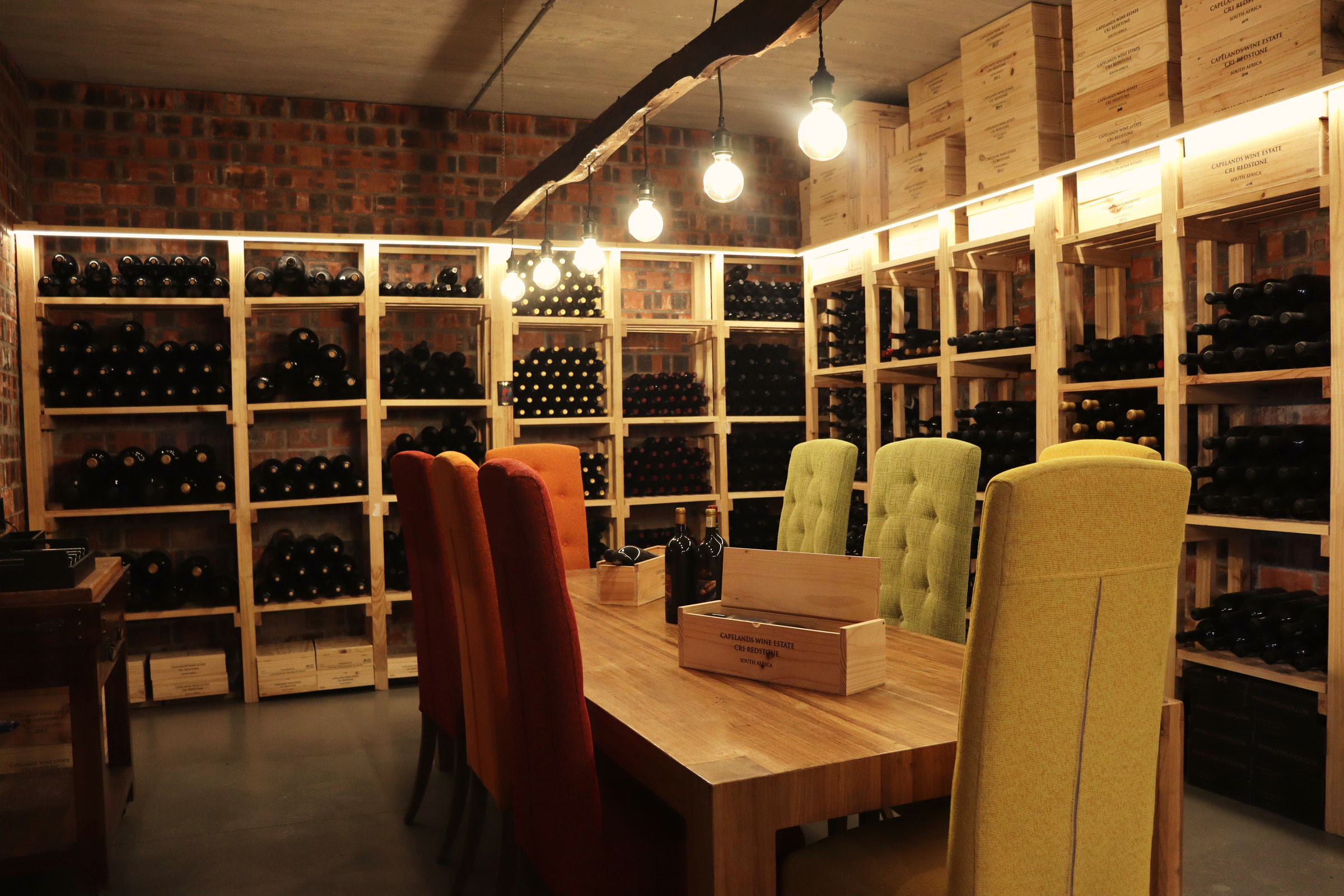 The tasting table in the cellar, lined with racks of wine