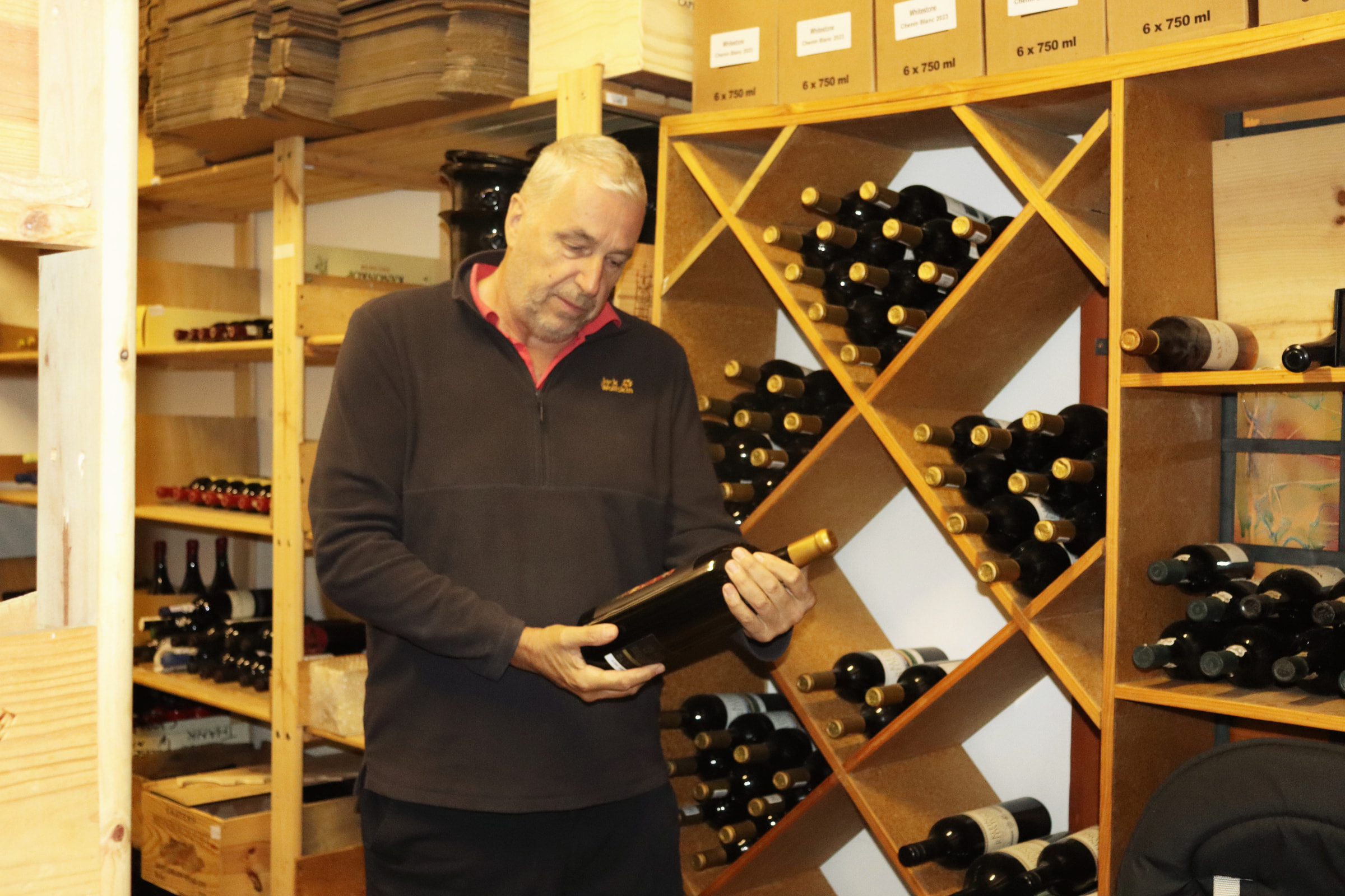 Johann Innerhofer choosing a bottle from the racks in the Capelands cellar