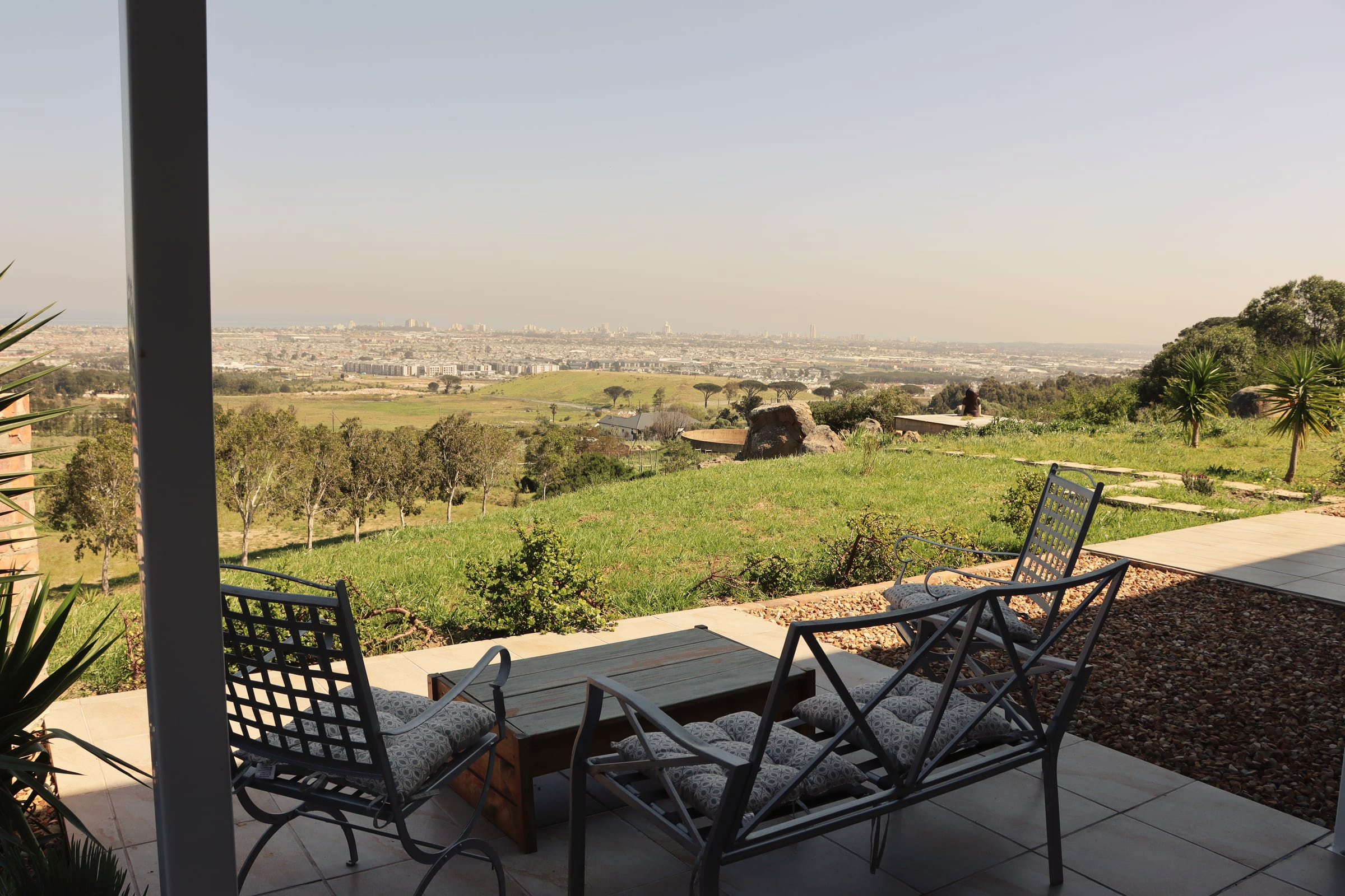 Chairs on the Ocean View Condo terrace, looking out over the valley